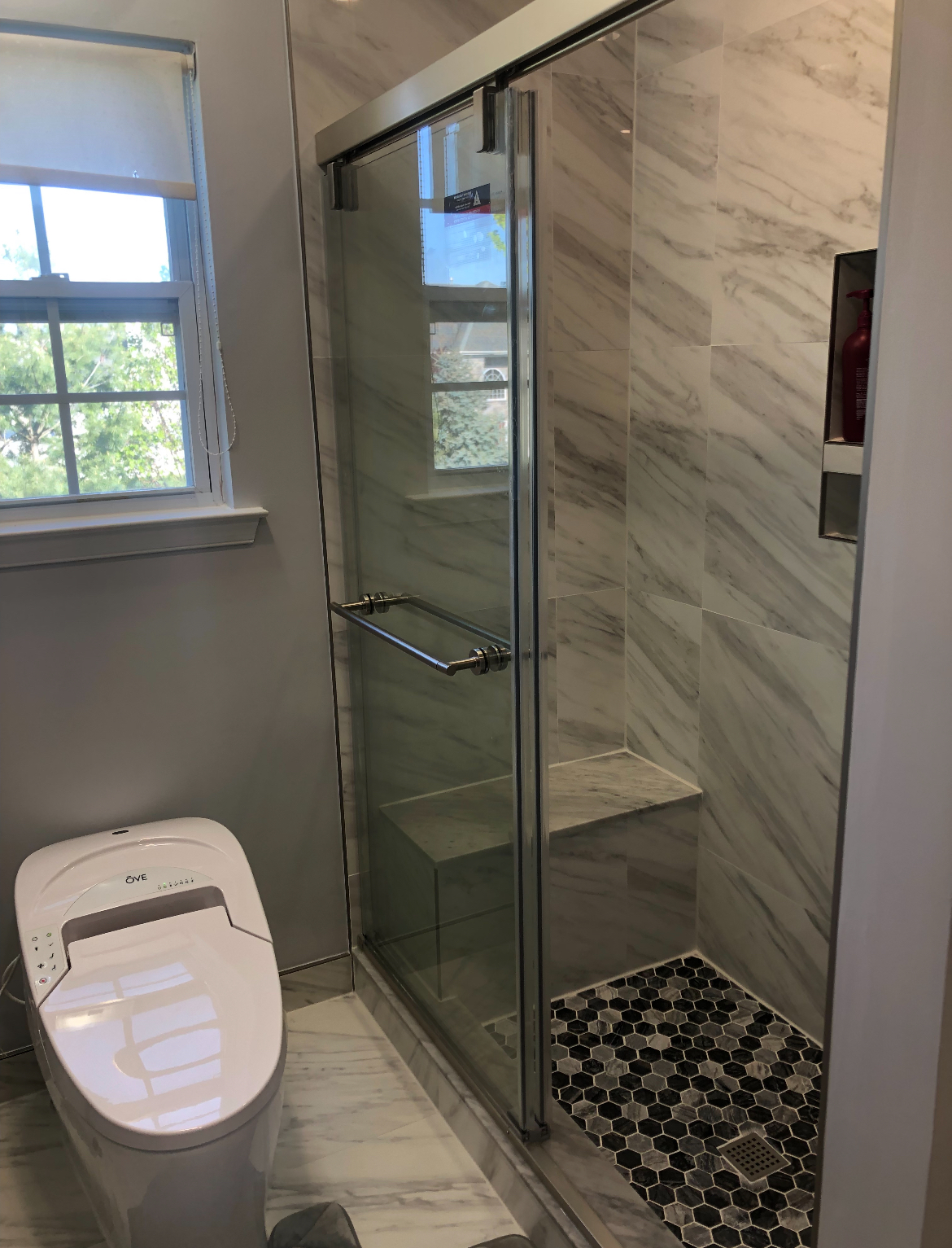 Clean white tile shower with niche