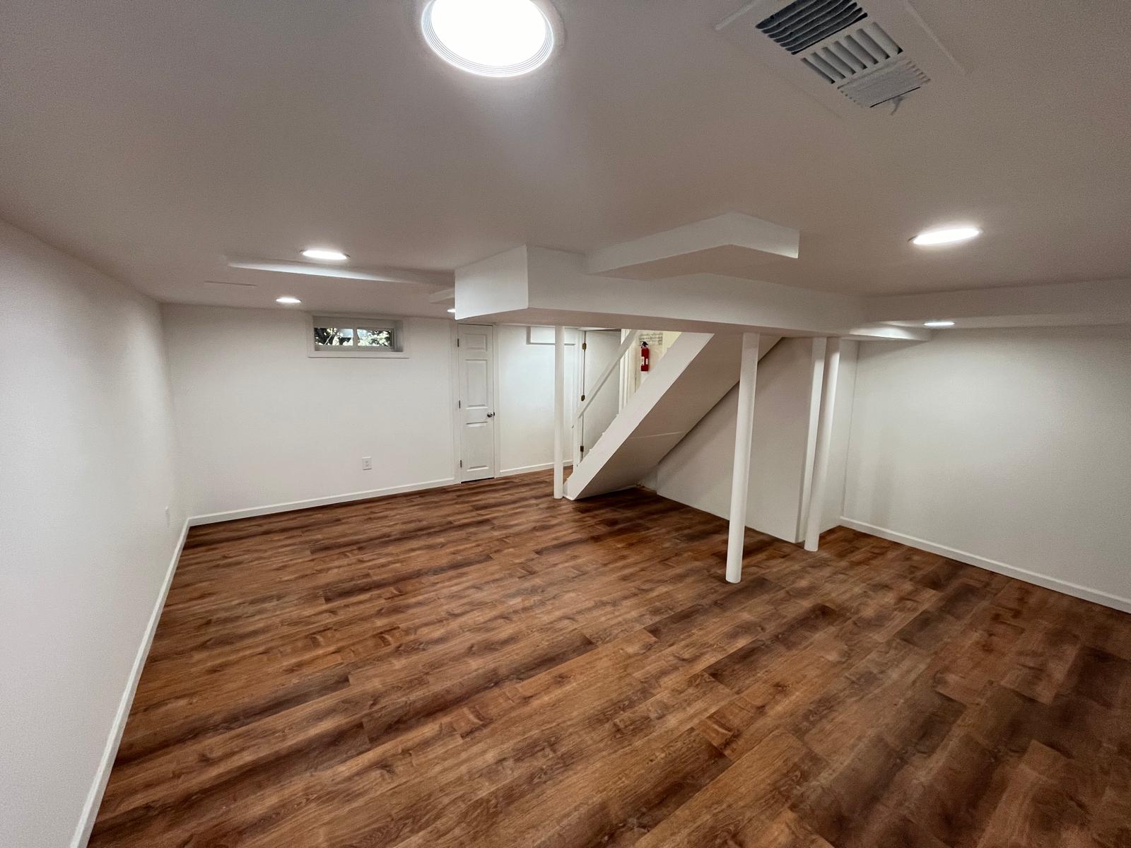 Cozy basement lounge with sectional and recessed lighting