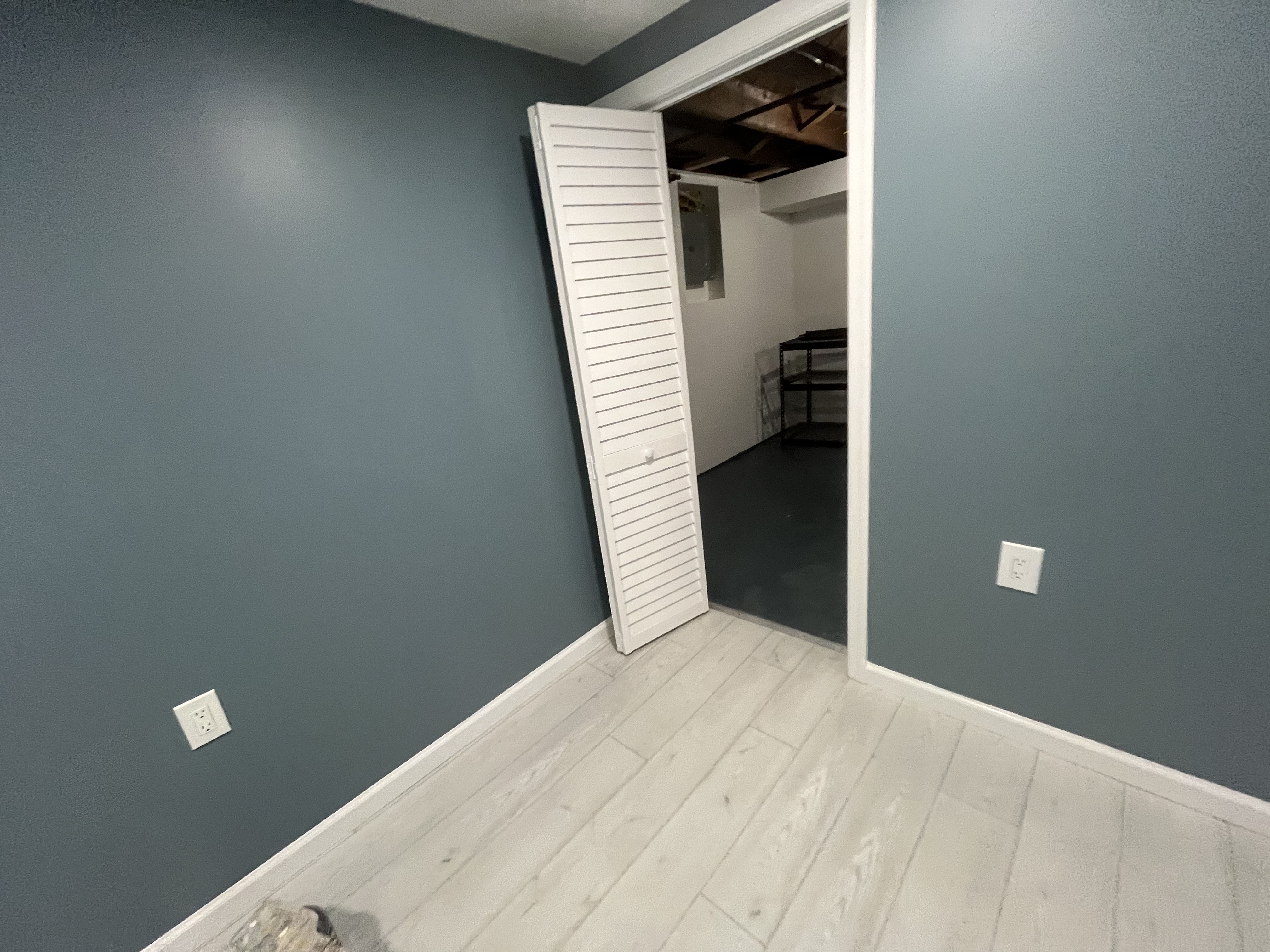 Basement with built-in media wall and LED strip accents