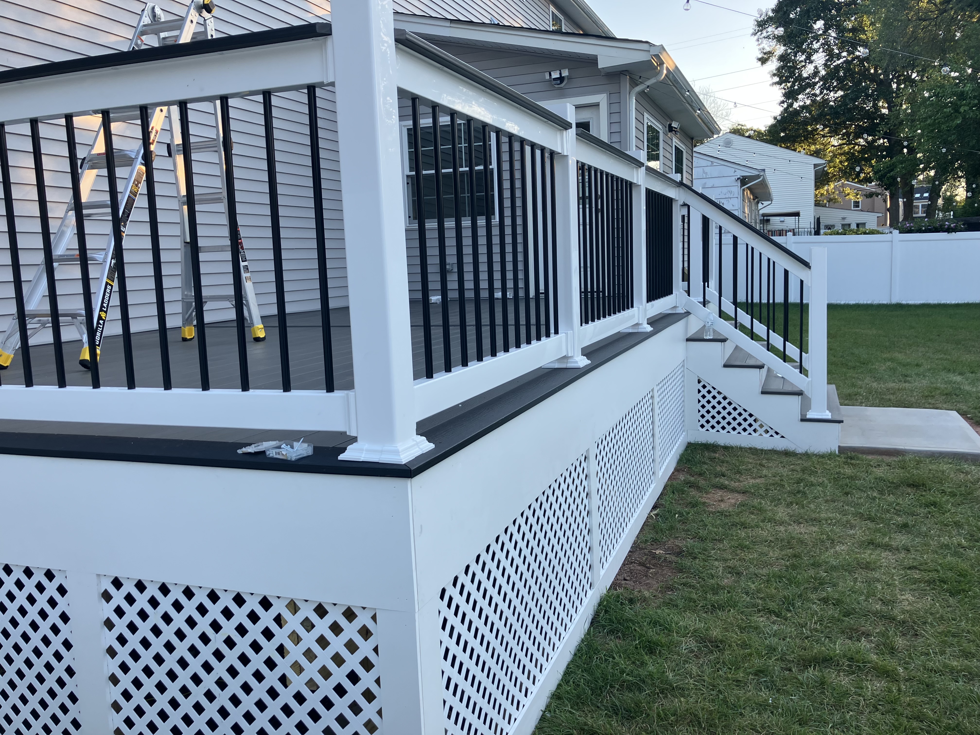 Refinished wood deck with post caps and lighting